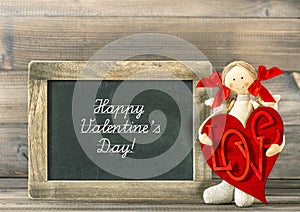 Valentines Day decoration. Funny girl with Red Heart and blackboard