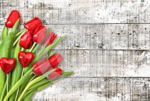 Valentines Day decoration. Red hearts tulip flowers wooden background