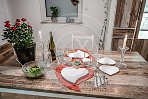 Valentines day dinner setting romantic love for two wooden table red heart shape candle light with roses