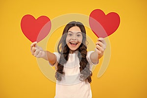 Valentines Day. Dreaming cute teen child with red heart. Happy teenager, positive and smiling emotions of teen girl.