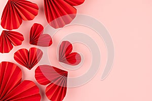 Valentines day festive background in asian style - red paper hearts of folded fans as pattern sideways border soar on gentle.