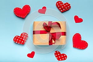 Valentines day flat lay on blue background, gift box, red hearts