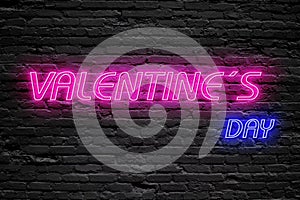Valentines day. fluorescent Neon tube Sign on dark brick wall. Front view. Can be used for online banner ads or background