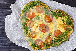 Valentines Day food. Heart shaped pizza with greens and mushrooms, vegetables on a dark background. Valentine`s day concept. Top