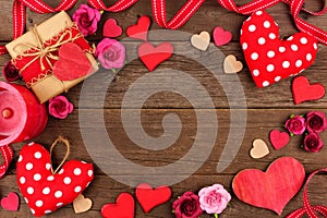 Valentines Day frame of hearts, gifts, flowers and decor on rustic wood