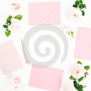 Valentines day. Frame with peonies, eucalyptus, pink envelope and diary with pen on white background. Flat lay, top view