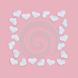 Valentines Day frame from white hearts on pink colored. Greeting card or invitation for wedding cards. Pastel colors