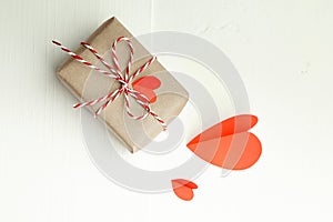 Valentines day gift box decorated with red paper hearts on white background