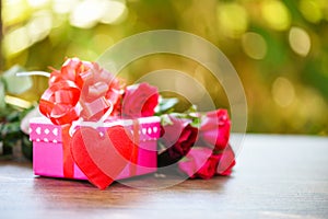 Valentines day gift box flower love concept / Pink gift box with ribbon bow red roses flower