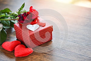 Valentines day gift box flower love concept Red gift box with ribbon bow red roses flower and heart