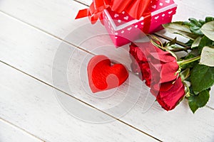 Valentines day gift box pink on white table background / Romantic red heart valentines red roses