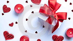 Valentines day gift box, red love hearts, romantic candle on white background. Romantic message template with copy space. Top View