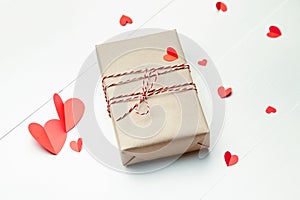 Valentines day gift box and red paper hearts on white