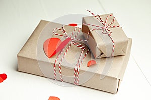 Valentines day gift box and red paper hearts on white