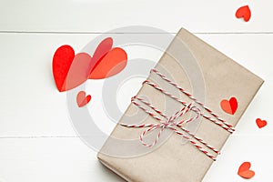 Valentines day gift box and red paper hearts on white background