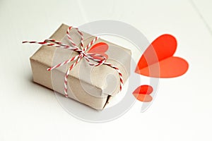 Valentines day gift box with red paper hearts on white background
