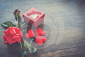 Valentines day gift box red on wood Red Heart Valentines day red rose flower and present box ribbon bow on old wooden