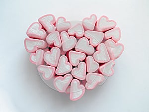 Valentines day gift concept - pink and white hearts marshmallows folded in the shape of a big heart on white