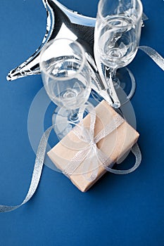 Valentines day greeting card. Empty Wine glasses for wine  on classic blue background. copy space, minimal february romance