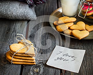 Valentines day heart shaped cookies and glass of milk.