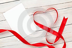Valentines day heart shaped red ribbon and blank greeting card