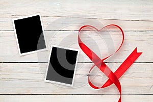 Valentines day heart shaped red ribbon and blank photo frames