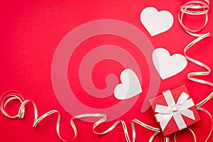 Valentines Day Hearts and gift box with ribbon on Red Background. copy space
