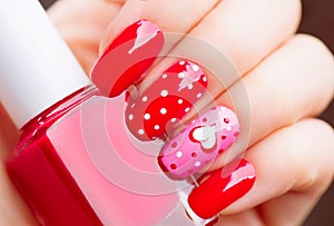 Valentines Day holiday manicure with painted hearts and polka dots