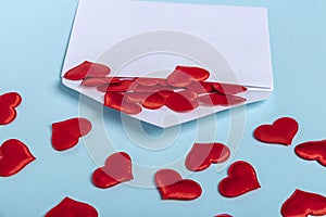 Valentines Day layout. Red hearts pours out of envelope on blue background. Template blank greeting card and envelope to wedding