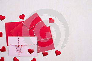 Valentines day and love concept. Red hearts and red pink letter cover on white wooden background