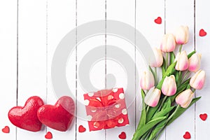 Valentines day and love concept. Two handmade red hearts with tulips