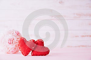 Valentines day and love concept. Two red hearts with pink rose flower on white wooden background