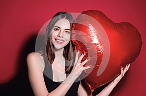 Valentines day, love heart. Portrait of lovely valentine girl hold red heart. Beautiful woman celebrate valentines day