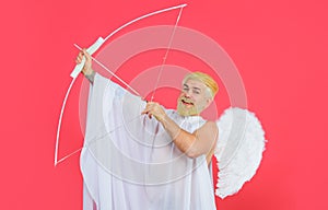 Valentines Day. Male angel with bow and arrows. Cupid in angelic wings shooting arrows of love.