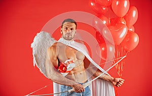 Valentines Day male. Sexy angel man with angels wings. Arrow of love, cupid, amour. February 14.  on red.