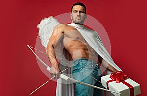 Valentines Day man angel. Sexy guy with angels wings. Cupid. Amour. February 14. Arrow of love. Isolated on red.