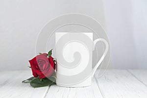 Valentines day mug, cup on the wooden table and white background with red rose
