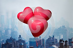 Valentines day in the New York city. Three red balloons in form of heart flying over Manhattan and skyscrapers. Ð¡oncept.