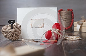 Valentines day photo frame or greeting card and handmade hearts over wooden table.