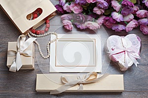 Valentines day photo frame or greeting card and handmade hearts over wooden table.