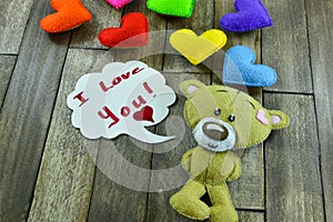 Valentines Day postcard. Teddy Bear and colourful hearts