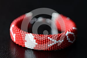 Valentines Day red beaded bracelet on a dark background