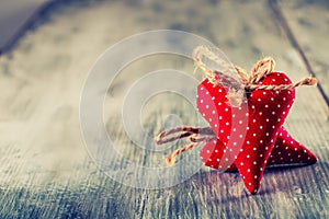 Valentines day. Red cloth handmade hearts on wooden background