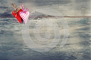 Valentines day. Red cloth handmade hearts on wooden background