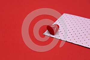 Valentines day red heart on pink dots envelope. Vivid color. Valentine's day concept. Copy space. Space for text.