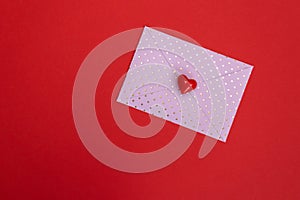 Valentines day red heart on pink dots envelope. Vivid color. Valentine's day concept. Copy space. Space for text.