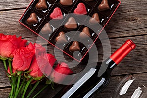 Valentines day with red roses, wine and chocolate