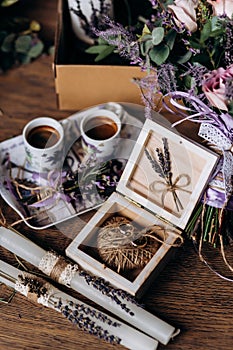 Valentines day romantic dinner table setting marry me wedding engagement ring in box with lavender gift cup of coffee surprise on