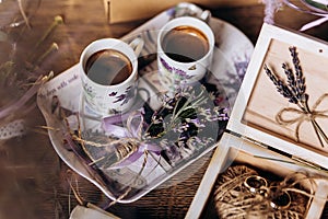 Valentines day romantic dinner table setting marry me wedding engagement ring in box with lavender gift cup of coffee surprise on
