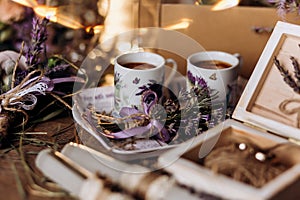 Valentines day romantic dinner table setting marry me wedding engagement ring in box with lavender gift cup of coffee surprise on